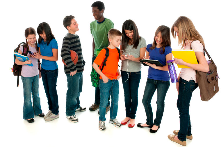 A diverse group of tweens using various electronic devices.